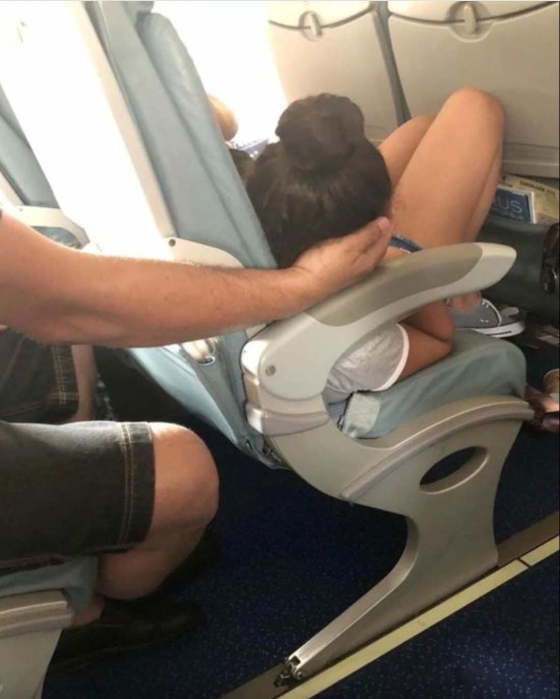 Dad sparks online debate after cradling daughter’s head for 45 minutes so she could sleep during a flight